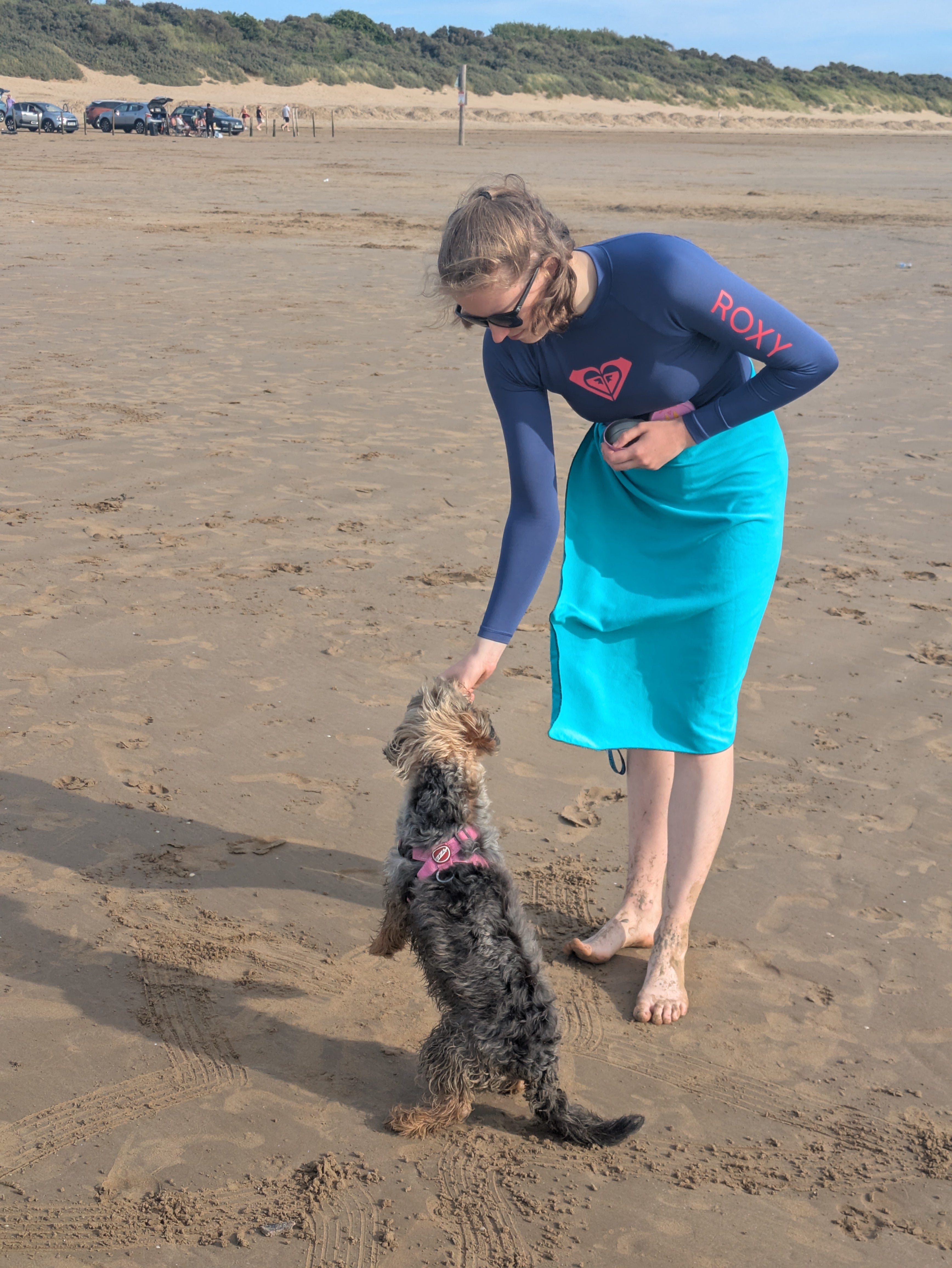dog eating a treat from a woman’s hand