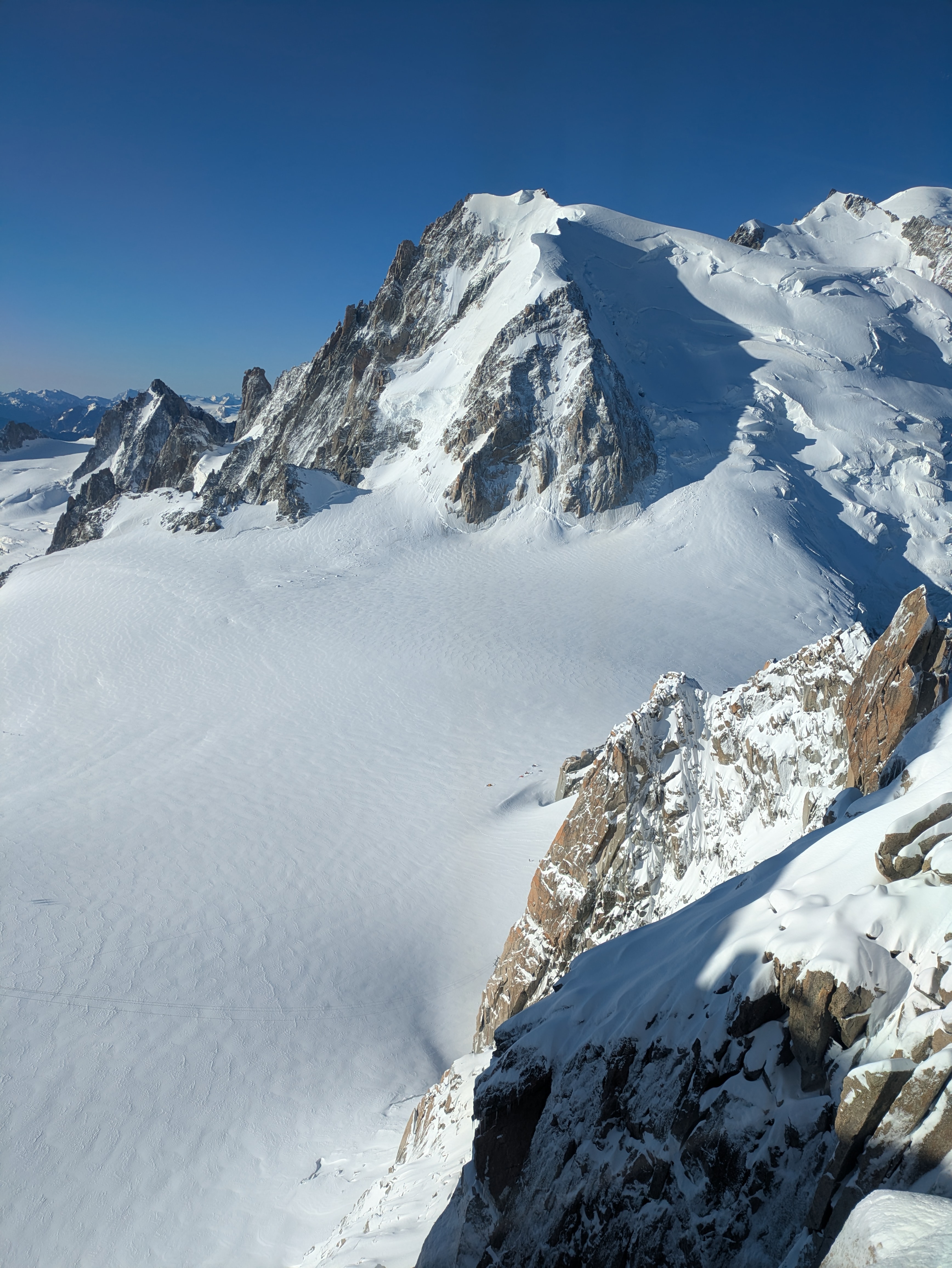 Tiny tents dotted in the snow from high above